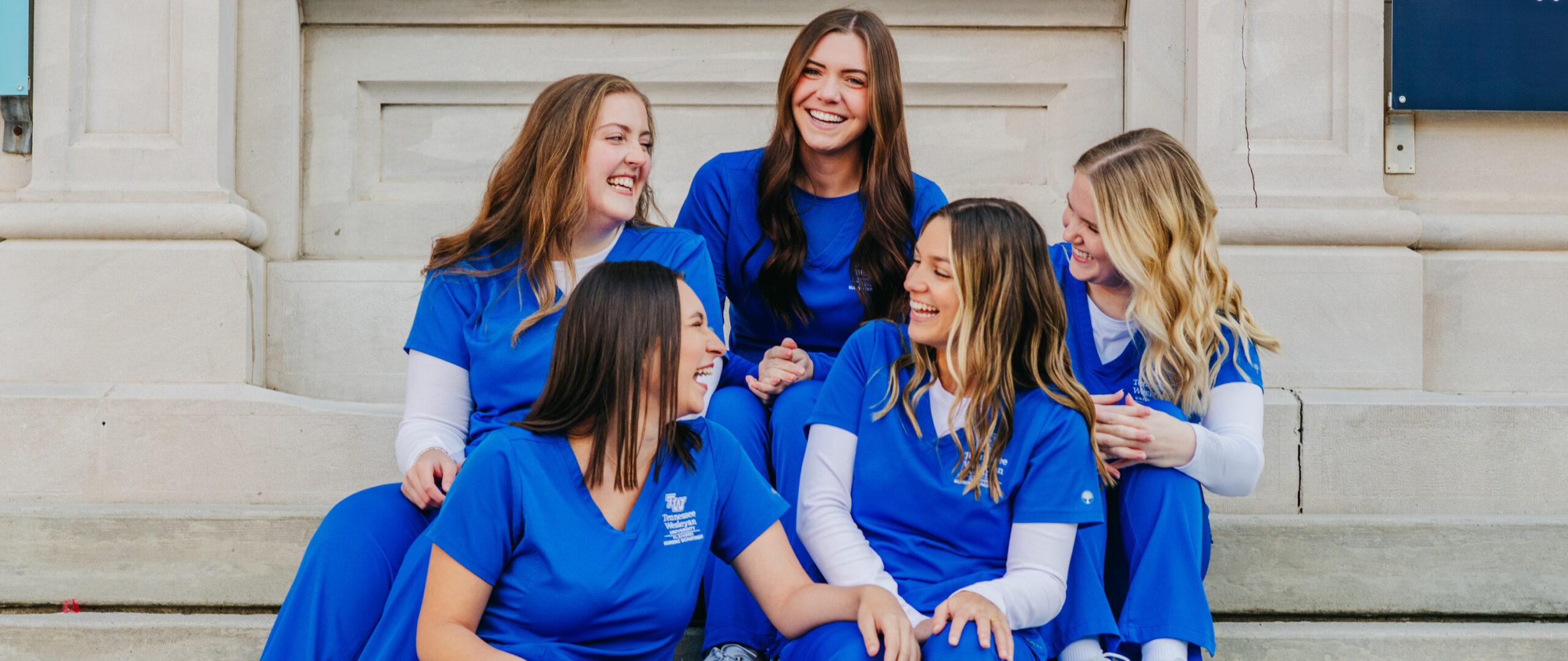 five senior nursing students pose on the steps of a building in knoxville