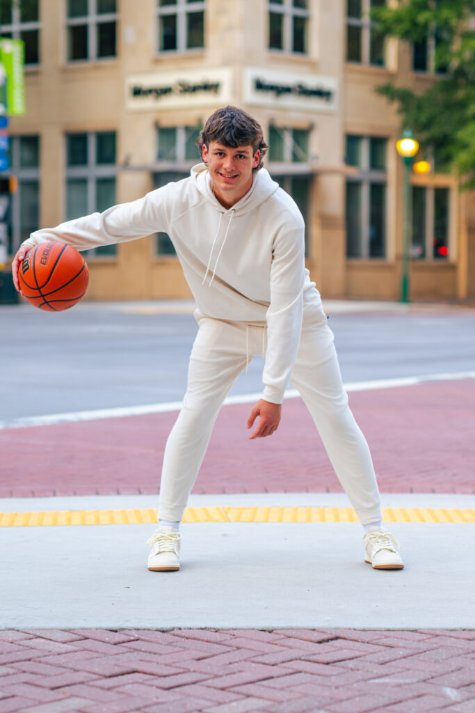a basketball player poses for story-driven senior photo session