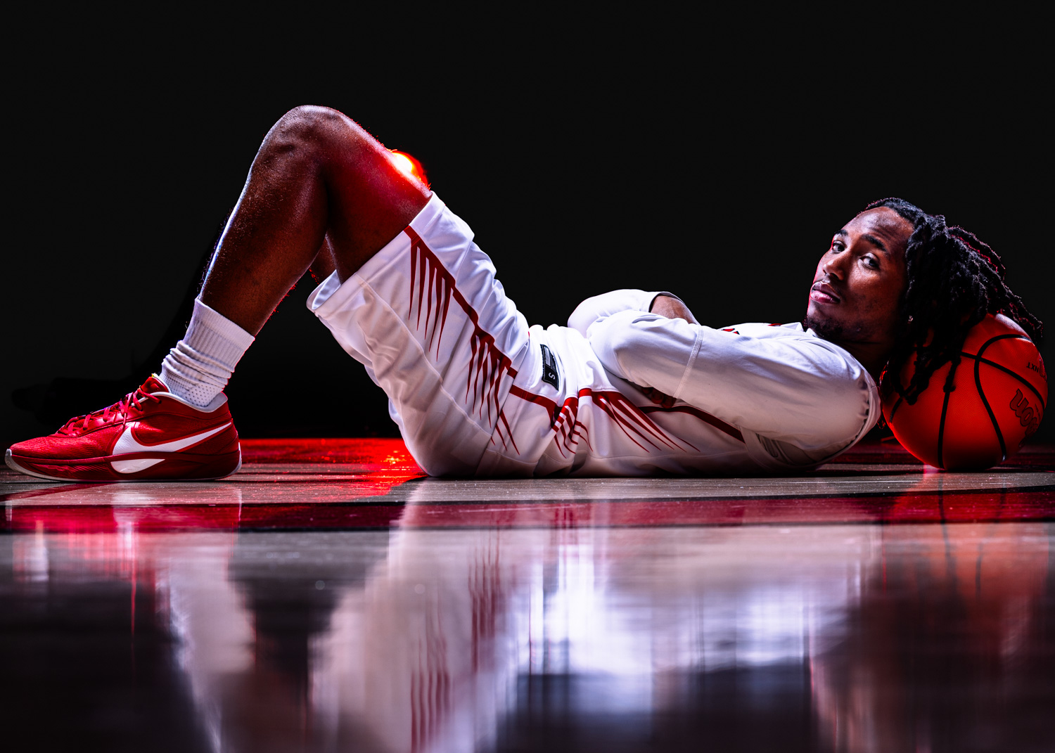 a high school basketball player poses during media day